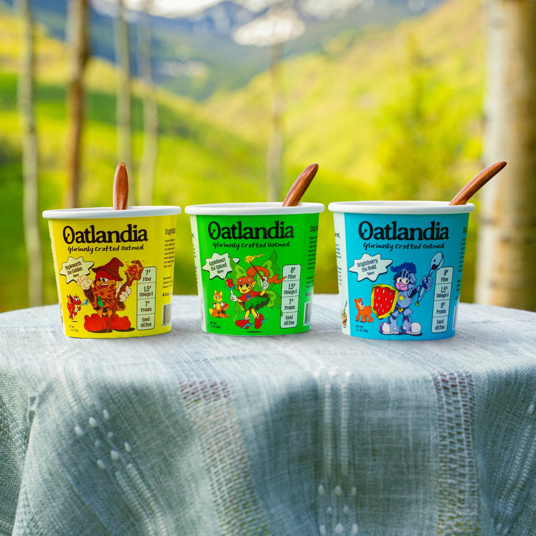 Mapleworth, Appleheart and Brightberry oatmeal cups with wooden spoons on an outdoor table